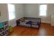 bedroom with hardwood floors and a crib at 509 E Church St, Nashville, NC 27856