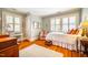 Bright bedroom with hardwood floors, window shutters, and charming decor at 205 N Boundary St, Chapel Hill, NC 27514