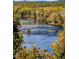 Scenic river view with fall foliage and rocky shoreline at 160 Blue Butterfly Dr, Angier, NC 27501