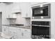 Stainless steel appliances and white cabinetry highlight this modern kitchen at 317 Highland Ridge Ln, Knightdale, NC 27545