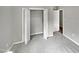Bedroom with grey carpet, double door closet, and access to another room at 615 Wildaro Ct, Hillsborough, NC 27278