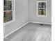 Spacious bedroom with neutral carpeting and two windows at 615 Wildaro Ct, Hillsborough, NC 27278