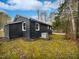 Dark-colored house with a small front porch and gravel driveway at 615 Wildaro Ct, Hillsborough, NC 27278
