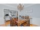 Spacious dining room with a view into the living room and large windows at 1012 Maple Ridge Ct, Burlington, NC 27217