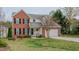 Brick two-story house with a two-car garage and well-manicured lawn at 1012 Maple Ridge Ct, Burlington, NC 27217