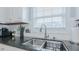 Double stainless steel sink with modern faucet and tile backsplash at 1012 Maple Ridge Ct, Burlington, NC 27217