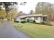Ranch home with carport, landscaping, and a long driveway at 124 Jack Bennett Rd, Chapel Hill, NC 27517