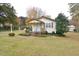 House exterior featuring a front porch and well-maintained lawn at 124 Jack Bennett Rd, Chapel Hill, NC 27517