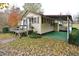 Home with a carport, ramp, and well-maintained lawn at 124 Jack Bennett Rd, Chapel Hill, NC 27517