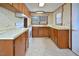 Classic kitchen with wood cabinets, white appliances, and patterned flooring at 124 Jack Bennett Rd, Chapel Hill, NC 27517