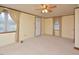 Bright living room with carpet, ceiling fan, and neutral walls at 124 Jack Bennett Rd, Chapel Hill, NC 27517