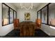 Modern meeting room with wood table, leather chairs, and large windows at 2165 Pink Peony Cir # 230, Durham, NC 27703