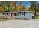 Newly renovated gray house with red door, gravel driveway at 509 Keith St, Knightdale, NC 27545