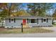 Newly renovated gray house with red door, and landscaping at 509 Keith St, Knightdale, NC 27545