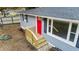 Gray house with red front door, wooden steps, and landscaping at 509 Keith St, Knightdale, NC 27545
