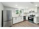 Modern kitchen with white cabinets, stainless steel appliances, and granite countertops at 509 Keith St, Knightdale, NC 27545
