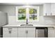 Modern kitchen sink and countertops with granite and white cabinets at 509 Keith St, Knightdale, NC 27545