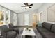 Living room with gray walls, ceiling fan, and view of the front yard at 509 Keith St, Knightdale, NC 27545