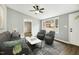 Spacious living room with gray walls, dark furniture, and large windows at 509 Keith St, Knightdale, NC 27545