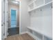 Entryway or mudroom with built-in bench, hooks, and shelves at 201 Wash Hollow Dr, Wendell, NC 27591