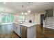 Kitchen island with granite countertops, stainless steel dishwasher, and hardwood floors at 201 Wash Hollow Dr, Wendell, NC 27591