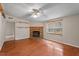 Living room with wood floors, fireplace, and ceiling fan at 336 N Raleigh Farms Rd, Youngsville, NC 27596