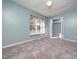 Well-lit bedroom with a window, closet, and neutral carpet at 769 Rawls Dr, Raleigh, NC 27610