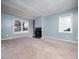 Spacious living room with fireplace and carpeted floors at 769 Rawls Dr, Raleigh, NC 27610