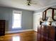 Bedroom with hardwood floors, large window, and built-in dresser at 823 E Holly St, Rocky Mount, NC 27801