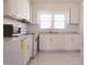 Kitchen with white cabinets, new appliances, and tile floor at 823 E Holly St, Rocky Mount, NC 27801