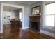 Living room with hardwood floors, fireplace, and view of kitchen at 823 E Holly St, Rocky Mount, NC 27801
