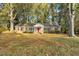 Front view of a brick ranch house with a lush lawn at 910 Parham St, Henderson, NC 27536