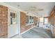 Enclosed porch with brick walls and ceiling fan at 910 Parham St, Henderson, NC 27536