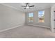 Bright bedroom with carpet, ceiling fan and two windows at 121 Pearl St # 4, Garner, NC 27529