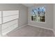 Bedroom with carpet and a large window at 121 Pearl St # 4, Garner, NC 27529