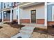 Townhouse front entrance with brick accents and a dark brown door at 121 Pearl St # 4, Garner, NC 27529