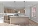 Modern kitchen featuring an island, stainless steel appliances, and light wood cabinets at 121 Pearl St # 4, Garner, NC 27529