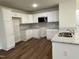 Modern kitchen with white cabinets and granite countertops at 131 Tulipfield Way, Benson, NC 27504