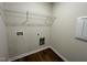 Laundry room with shelving and hookups for washer and dryer at 131 Tulipfield Way, Benson, NC 27504