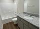 Bathroom includes a single vanity, granite countertop, and tub shower combo at 396 Magnolia Run Way, Benson, NC 27504