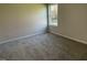 Spacious bedroom with neutral carpeting and a large window at 396 Magnolia Run Way, Benson, NC 27504