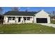 New construction home with gray siding, black garage door, and a front porch at 396 Magnolia Run Way, Benson, NC 27504