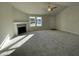 Living room with high ceilings, fireplace, and carpeted floors at 396 Magnolia Run Way, Benson, NC 27504