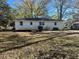 Large backyard with a deck and mature trees at 445 N Dunn St, Angier, NC 27501