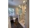 Modern bathroom with walk-in shower, toilet and wood-look floor at 445 N Dunn St, Angier, NC 27501
