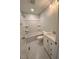 Updated bathroom with white vanity, tub, and shower at 445 N Dunn St, Angier, NC 27501