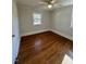 Bright bedroom with hardwood floors and ceiling fan at 445 N Dunn St, Angier, NC 27501