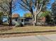 Front view of a charming white house with a spacious lawn at 445 N Dunn St, Angier, NC 27501