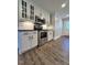 Modern kitchen with stainless steel appliances and white cabinets at 445 N Dunn St, Angier, NC 27501