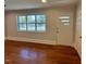 Living room with hardwood floors and an exterior door at 445 N Dunn St, Angier, NC 27501
